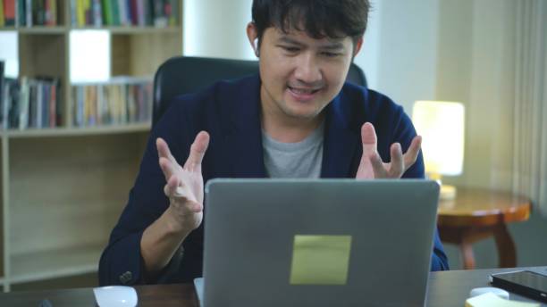 istock Asian businessman having a video call at home office. 1679518647