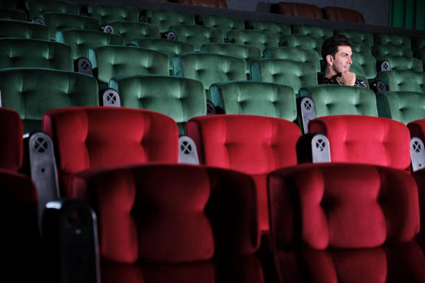 istock One man watches cinema alone, separate from other audiences at empty theaters. 1679519727
