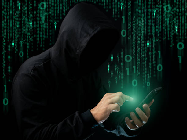 istock Hackers work on phone in the dark. The concept of information security in the Internet network and information espionage. 1679541372