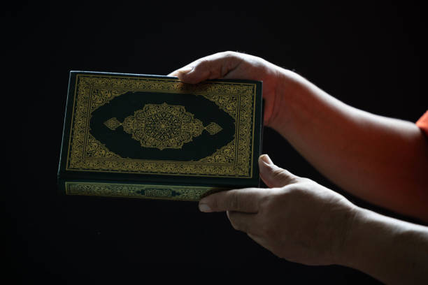 istock A Muslim man holds a Quran in his hand as . 1679563181