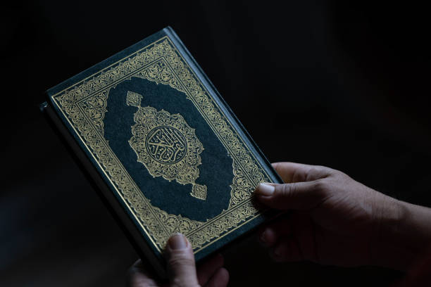 istock A Muslim man holds a Quran in his hand as . 1679563654