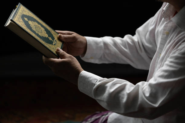 istock A Muslim man holds a Quran in his hand as . 1679563675