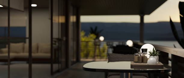 istock A relaxation area with a table on a modern and spacious balcony in the evening. 1679570945