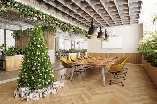 Eco-Friendly Open Plan Modern Office Interior With Christmas Decoration. Christmas Tree, Ornaments And Gift Boxes In Meeting Room