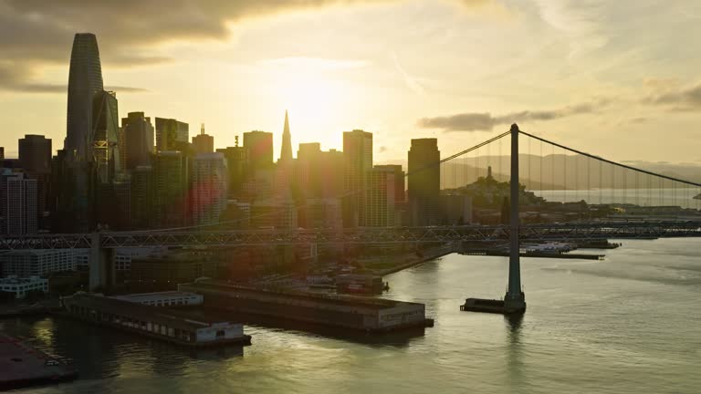 Aerial Shot of Bay Bridge Traffic Passing the San Francisco Skyline at Sunset