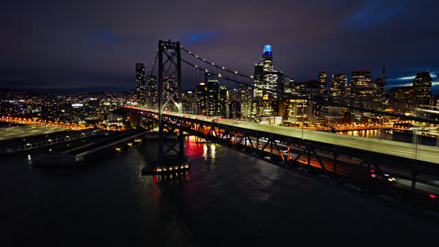 Drone Shot of Traffic on the Bay Bridge at Night with the San Francisco Skyline Beyond