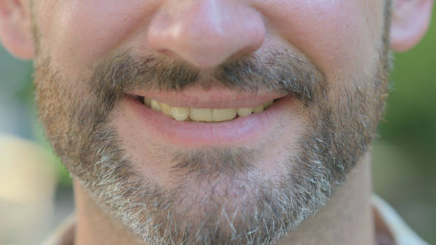 istock Close up of Smiling Male Lips 1679601547