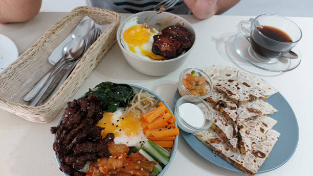 Overhead view of a foodie getting ready to eat korean and mexican dish for brunch