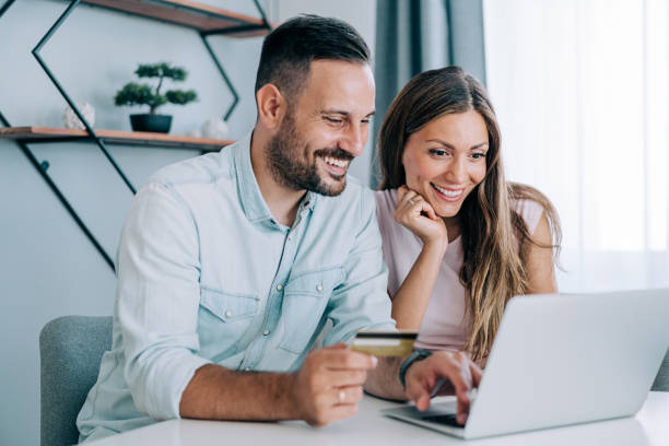 istock Lovely couple using laptop for online shopping. 1679665447