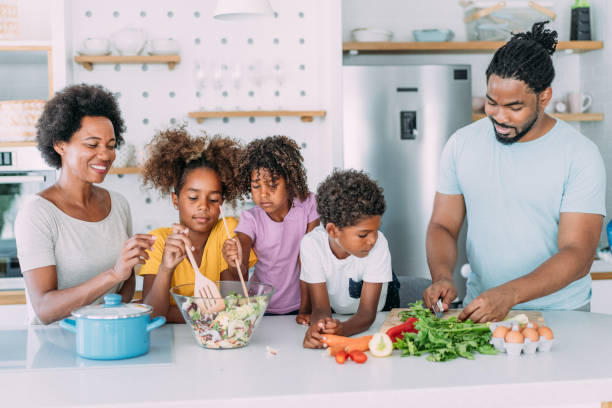 istock Happy family cooking together. 1679665884