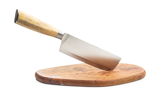 A knife stuck in a cutting board isolated on the white background.