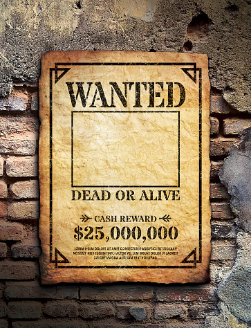 Wanted poster tacked on brick wall surface