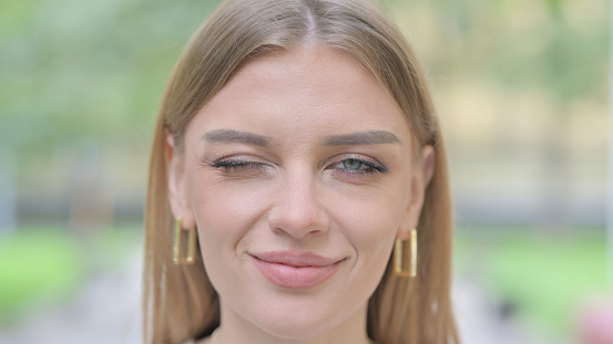 Close Up of Happy Woman Winking Her Eye