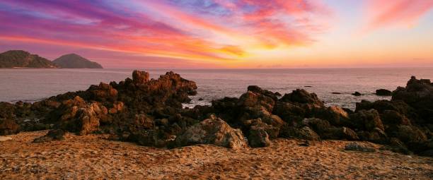 istock sunset at the beach with rocks 1679719475