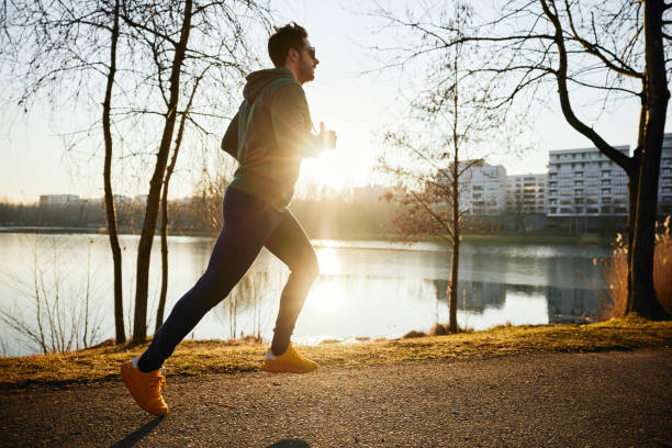 istock Male runner in park during autumn or winter sunset 1679731807