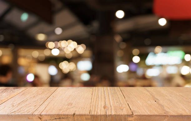 istock Mock up for space. Empty dark wooden table in front of abstract blurred bokeh background of restaurant . can be used for display or montage your product 1679739567