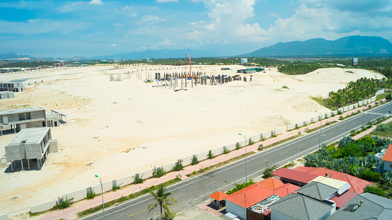 Construction of a bungalow of a new hotel in Cam Ranh in Vietnam in the sand dunes.