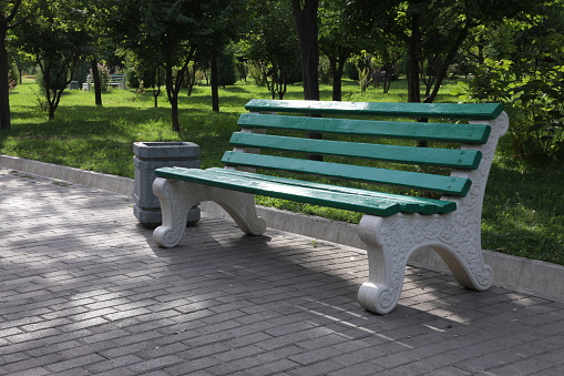 Green bench in the park. Park bench in the city park.