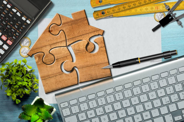 Wooden Jigsaw Puzzle Pieces Forming a House Shape stock photo