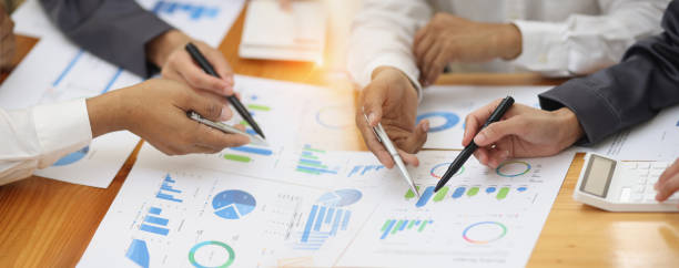 istock Group of  business hands with business financial documents. 1679770673