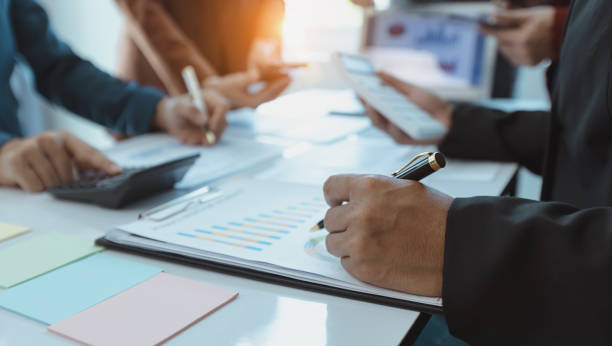 istock Group of  business hands with business financial documents. 1679771633