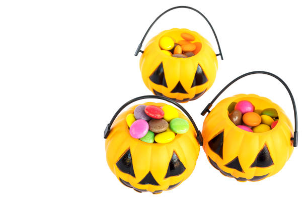 istock Halloween pumpkin face buckets with colorful candy inside isolated over white 1679775657