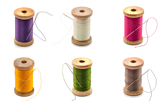 Collage of isolated wooden spool thread and needle