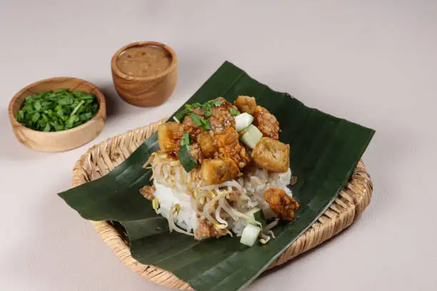 Nasi Lengko is Indonesian Traditional Dish, Rice Topped With Fried Slices Tofu, Tempeh and Peanut Sauce.