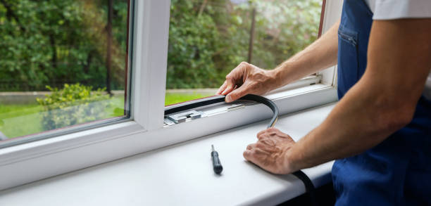 worker installing sealing tape on plastic window frame. copy space stock photo