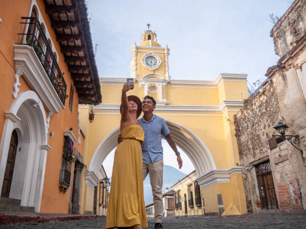 They travel and take a selfie with the old town on the background, Central America exploration.