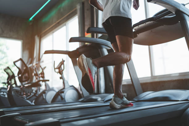 primer plano de los pies, corredor deportivo corriendo en cinta de correr en el gimnasio. entrenamiento cardiovascular. estilo de vida saludable, chico entrenando en gimnasio. concepto de carrera deportiva - gym fotografías e imágenes de stock