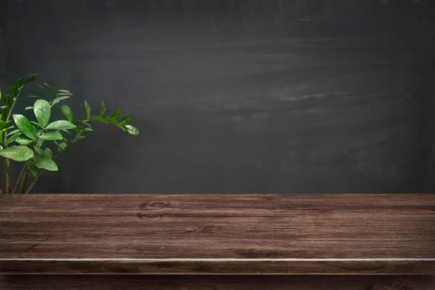 Desk with space on blank real blurred grunge black chalkboard