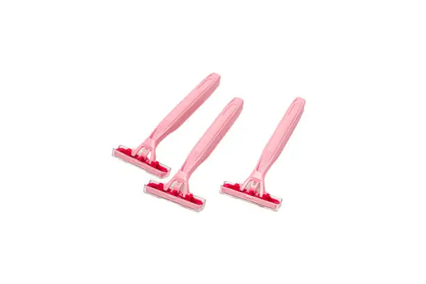 Photo of Pink lady shavers, razors on white background