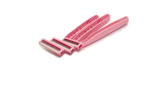 Photo of Pink lady shavers, razors on white background