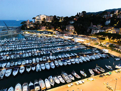 city ​​of italy in the light of lanterns, warm light, yachts on the canal, ships in the pier, nightlife, Italy Rapallo