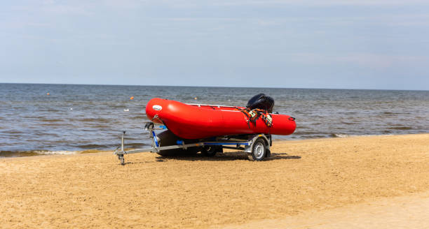 istock Red life saving boat  on the sea beach. 1679819864