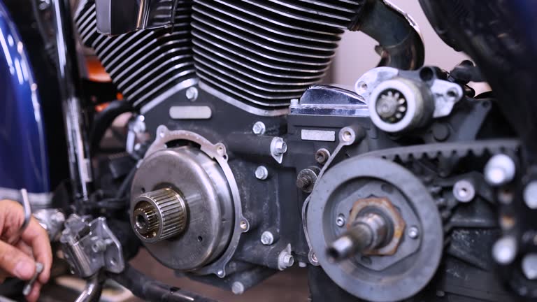 Mechanic using wrench and socket on motorcycle cylinder head 4k movie