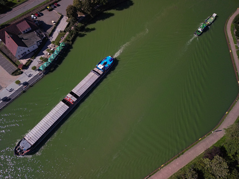 barge floats on the channel, water logistics, cargo transportation.