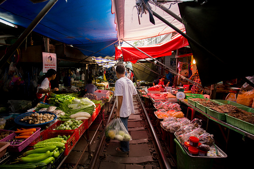 Bangkok, Thailand; 1st January 2023: Atmosphere and vendors at Maeklong Railway Market in Bangkok..