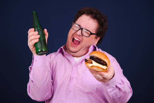 istock Funny hungry fat man eating burger. 1679851481
