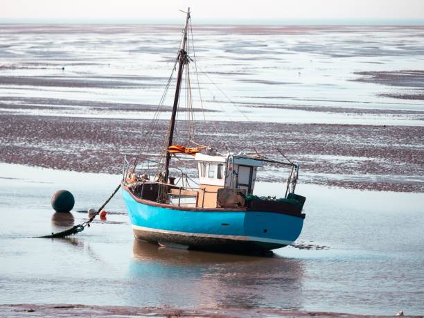 istock fishing boat aground at low tide UK 1679868651