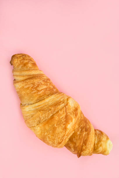 istock Croissant on pink background 1679879505