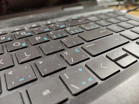 Dirty laptop keyboard with dust and crumbs