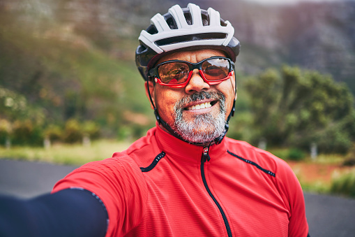Happy man, cyclist and portrait in selfie on mountain bicycle for photograph, picture or outdoor memory in nature. Male person or athlete smile in photo, happiness or cycling in fitness or travel