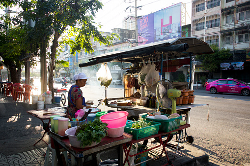Bangkok, Thailand; 1st January 2023: A young woman cooking in a  Street food stall on in Bangkok..
