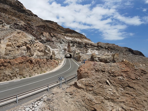 A tunnel cutting through the rocky hillside of Gran Canaria, an island of volcanic origin.