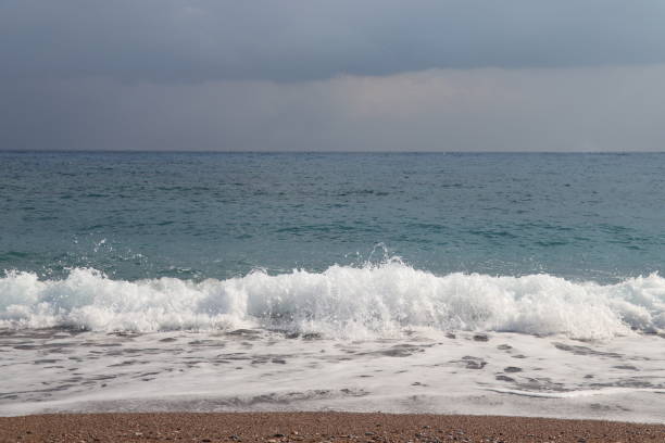 istock Big breaking ocean or sea wave on a beach 1679914067