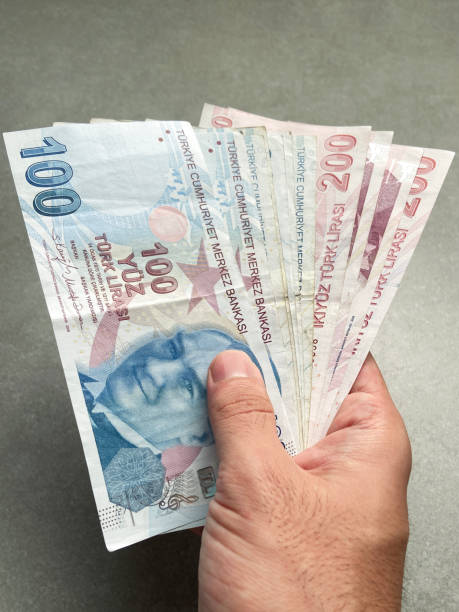 istock Hand holding Turkish lira banknotes 1679914624