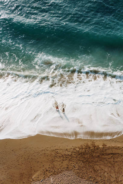 istock Two people at a beach as seen from above 1679928426