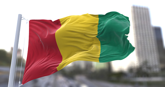 3d illustration flag of Guinea. Guinea flag isolated on the sky waving in the wind.